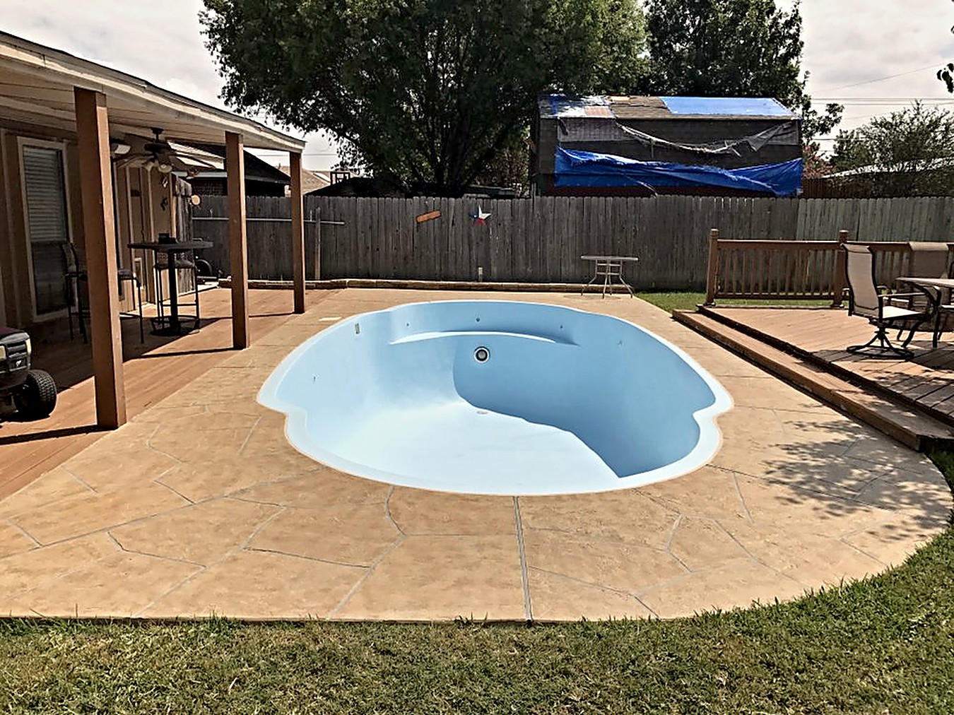 Kidney-shaped shell resurfaced, stamped concrete deck